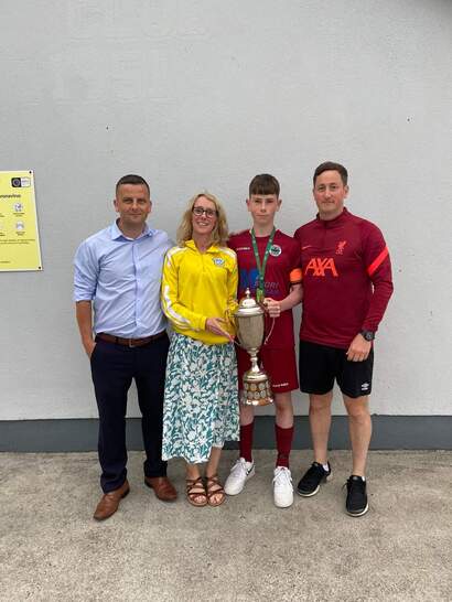 John Conway, Vanessa Lloyd  Aaron Treacy and Mark Duffy at the Soccer Clubhouse when Aaron returned with the Kennedy Cup. 