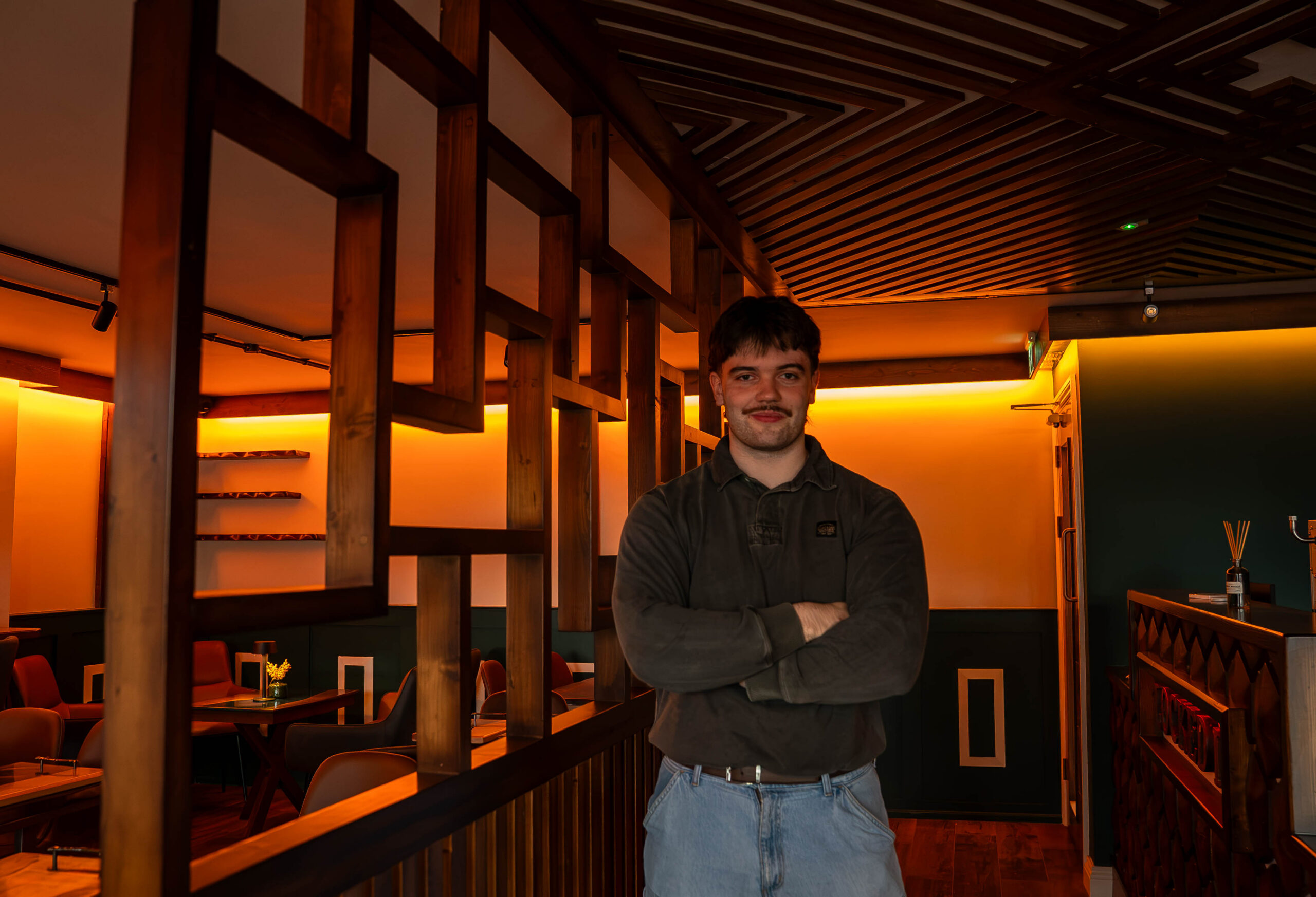 Kyle Blackweir inside his new coffee shop and Barbershop, Locked in.